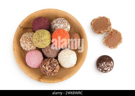 A variety of different truffles in a wooden bowl Isolated on a white background. Top view. Flat lay Stock Photo