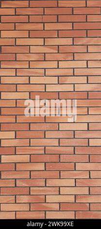 A vertical red-brown rectangular brick wall for use as a backdrop and background. Stock Photo