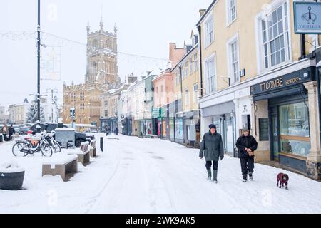 Heavy snow has fallen in the Cirencester in then Cotswolds. People are seen  out walking and playing in Cirencester park adn the Abbey grounds. Stock Photo