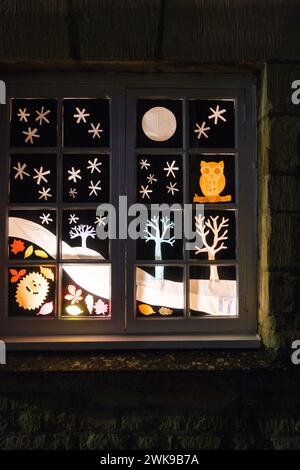 A house window split into sections with christmas a scenes in each one ...