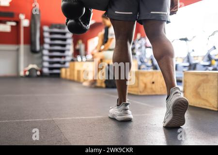Fit African American man training at a gym, holding boxing gloves, with copy space Stock Photo