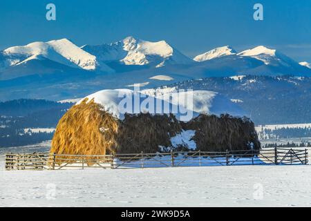 haystack below the flint creek range in winter near avon, montana Stock Photo