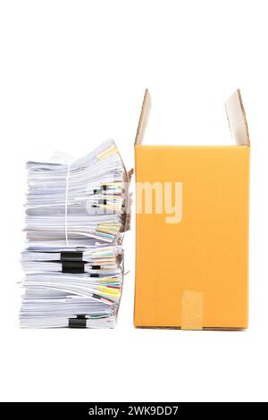 Stack of Documents and corrugated cardboard box isolated on white background. Stock Photo