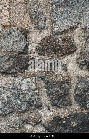 Texture of a stone. Old stone wall texture background. Grey stone wall as a background or texture. Stone wall of natural stones in different sizes. Si Stock Photo