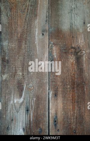 Wooden background. Faded and darkened old wood board due to atmospheric influences. Aged wooden background , wall texture. Brown wood with copy space. Stock Photo