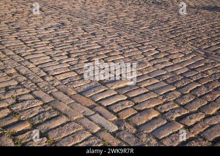 Close-up of rectangular tan and brown cobble style paving stones in street in early morning light, Old Port of Montreal, Quebec, Canada. Stock Photo