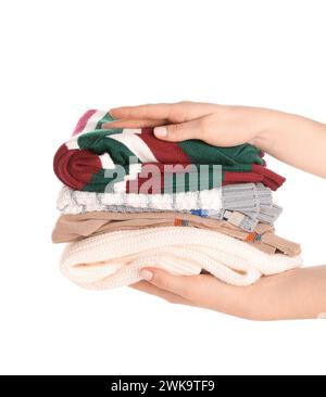 Female hands with stack of different stylish sweaters on white background Stock Photo