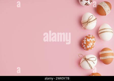 Composition with decorated Easter eggs on pink background Stock Photo