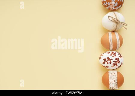 Composition with decorated Easter eggs on beige background Stock Photo