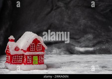 Toy Christmas red house on a black background. Stock Photo