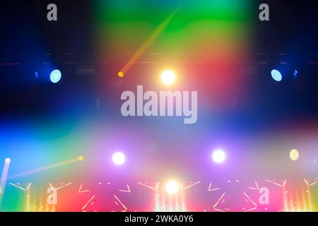 Bright festive multi-colored stage lighting with optical flare and rays from lighting lamps. Stock Photo