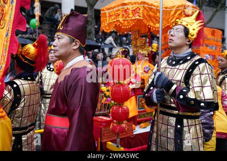 Paris, France, 18th February, 2024. Chinese men procession in the street for the New Year Parade in Chinatown - Jacques Julien/Alamy Live News Stock Photo