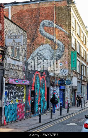 Colourful urban landscapes with large murals on side of buildings, Brick lane London's East End Tower Hamlets England UK Stock Photo