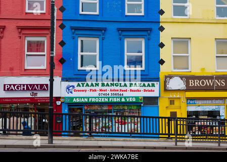 Brightly coloured retail shops on South Road in Southall West London England UK Stock Photo