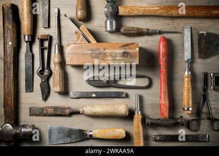 Close up of a group of disused hand tools on a work bench. Stock Photo
