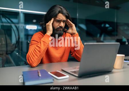 Stressed Eastern Businessman with Laptop at Office Stock Photo