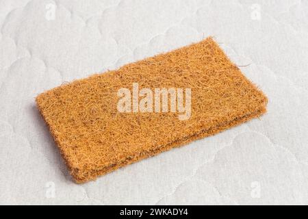 A rectangular sample of coconut coir used in the production of modern mattresses with independent spring blocks. Stock Photo