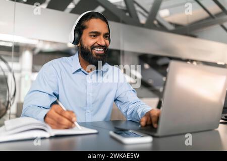 Young indian man having online training or attending webinar Stock Photo