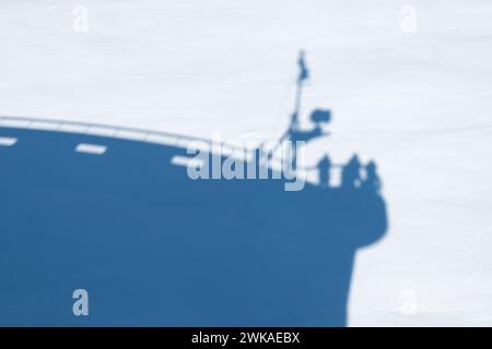 Shadow of cruise ship bow on snowy sea ice. Stock Photo