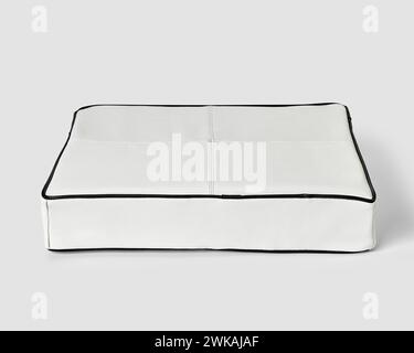 Minimalist floor cushion in white leather with black piping Stock Photo