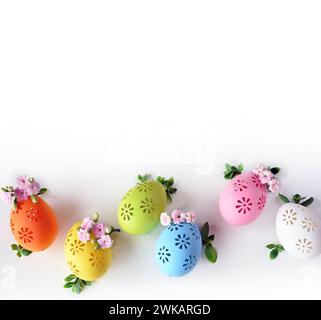 Collection of stylish colors eggs with flowers for Easter celebration on white background. Holiday concept. Stock Photo