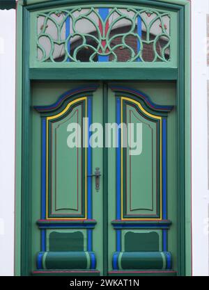 Detailed view of a green door from a rural house in the old country , called Altes Land, near Hamburg, the door is only used for festive occasions suc Stock Photo