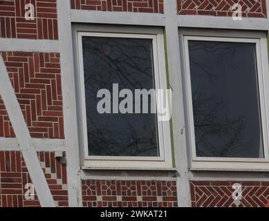 Detailed view of a wall with window from a rural half-timbered house in the old country near Hamburg, red bricks, white joints and wooden beams, fine Stock Photo
