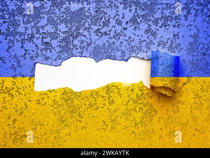 Torn yellow blue paper with space for text on white background. The Ukrainian flag is torn in the middle. Stock Photo