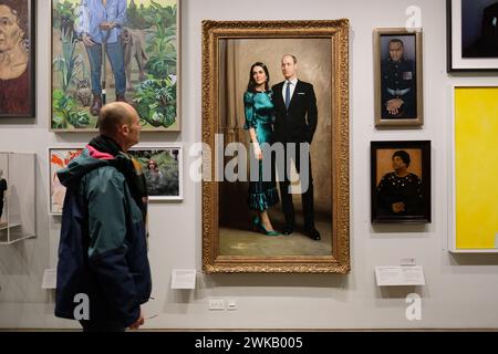 National Portrait Gallery London UK - visitors look at a portrait of The Duke and Duchess of Cambridge by artist Jamie Coreth painted in 2022 Stock Photo