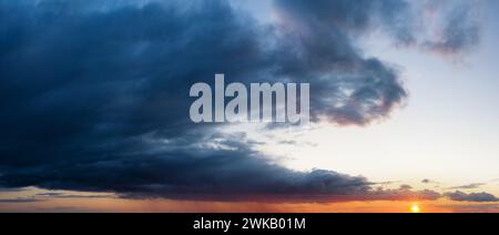 Sunset sky with dark clouds. Landscape background. Stock Photo