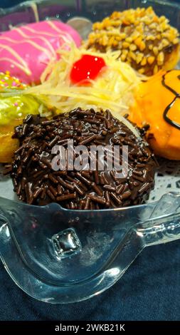 Close up of donuts with various color variants and toppings Stock Photo ...