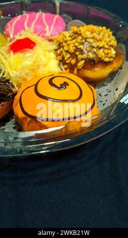 Close up of donuts with various color variants and toppings Stock Photo ...