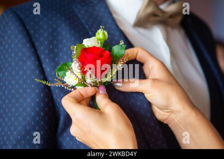 Mom helps her son get ready for the wedding, Stock Photo