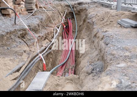 underground electric cable infrastructure installation. Construction site with A lot of communication Cables protected in tubes. electric and high-spe Stock Photo