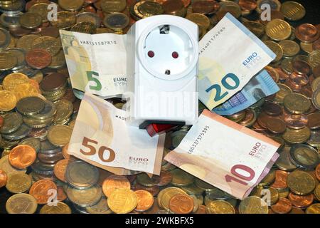 plug adapter and money, symbolic image of electricity costs Stock Photo
