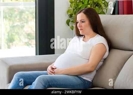Tired woman yawning covering mouth Stock Photo