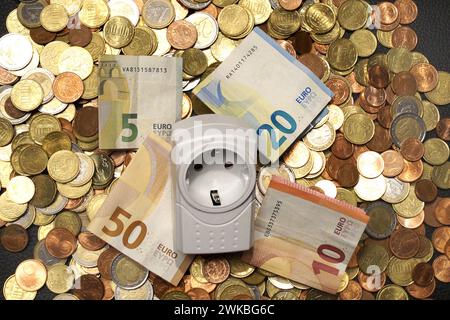 plug adapter and money, symbolic image of electricity costs Stock Photo