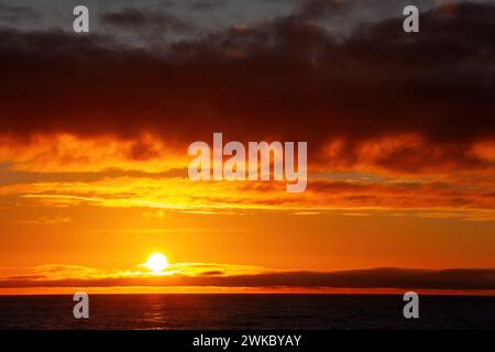 Sunset over an unusually calm Drake Passage, the ocean strait beween Patagonia in South America and Antarctica, photographed from a ship. Stock Photo