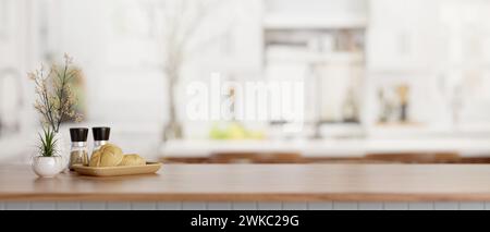 A close-up image of a bread basket, spice bottles, and a copy space on a wooden kitchen countertop in a modern white kitchen. 3d render, 3d illustrati Stock Photo