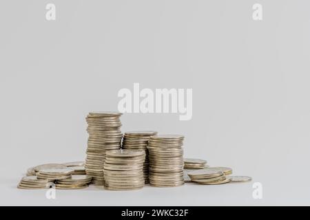 Stacks of coins in various sizes isolated on white background Stock Photo