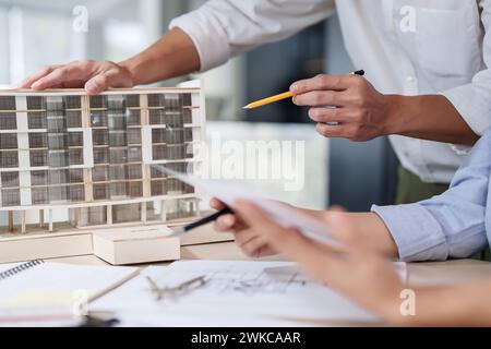 Male architect inspecting house model Stock Photo - Alamy