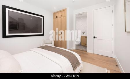 A modern, cozy, spacious bedroom with a king-size bed Stock Photo