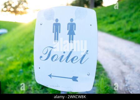 A roadside sign indicating restroom location. Stock Photo