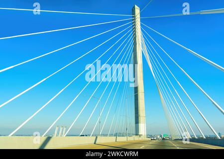Driving on the cable-stayed bridge in California. Dynamic perspective set against a clear blue sky. Stock Photo