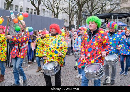 Cologne, Germany - February 11, 2024  Funny Street musicians in colorful clothes celebrating the women's carnival, Rosenmontag Parade( the rose monday. Stock Photo