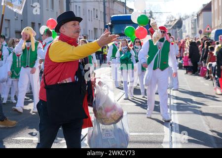 Cologne, Germany - February 11, 2024  Funny Street musicians in colorful clothes celebrating the women's carnival, Rosenmontag Parade( the rose monday. Stock Photo