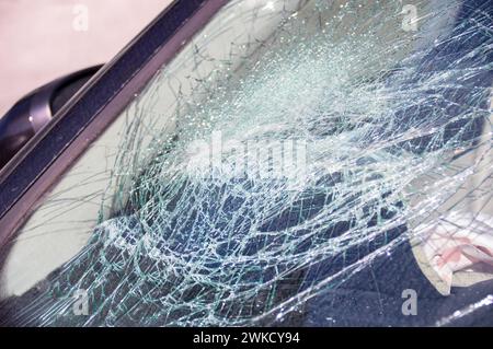 Detail of damage to windscreen of car shattered by vandalism Stock Photo