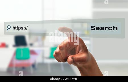 Concept shot of a businessman hand pointing at search bar on virtual screen at office Stock Photo