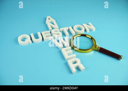 Question and Answer alphabet letters with magnifying glass on blue background Stock Photo