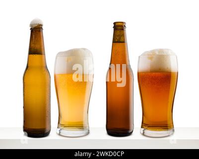 Bottles and glasses of different beer on white shelf and white background. Stock Photo